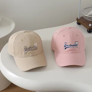 Close-up of kids cotton baseball caps with Insbobo letter embroidery and bear pattern