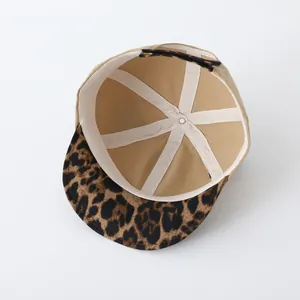 Detailed interior of a kids baseball cap featuring leopard print brim and reinforced stitching