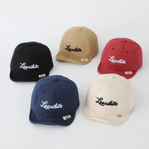 Detail of five colored baby baseball caps with soft brims and embroidered Leonikita logo
