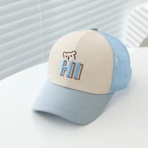 Detail of blue and beige mesh baseball cap for kids with bear and HI embroidery