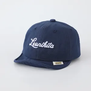 Detail of navy blue cotton baseball cap featuring white Leonikita script embroidery