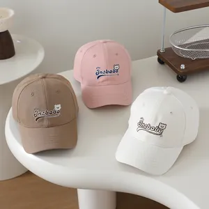 Three Korean-style kids baseball caps in pink, khaki, and beige with cute bear embroidery