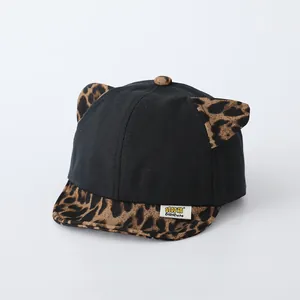 Infant baseball cap with leopard print brim and ears, black fabric with soft sun peak