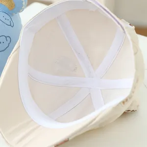 Internal view of a kids' breathable mesh sun hat with white crisscross support straps