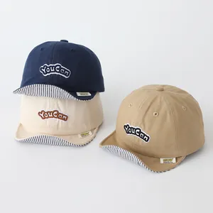 Kids cotton baseball caps with Youcan embroidery in navy, beige and khaki colors