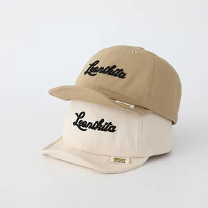 Detail of khaki and beige soft cotton baseball caps with Leonikita embroidery