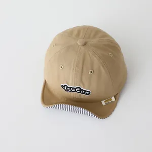 Khaki baby baseball cap with soft brim and youcan embroidery shown from top view