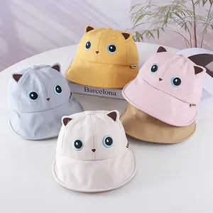 Close-up of cute cat ear sun hats for kids in yellow, pink, blue, beige, and khaki colors