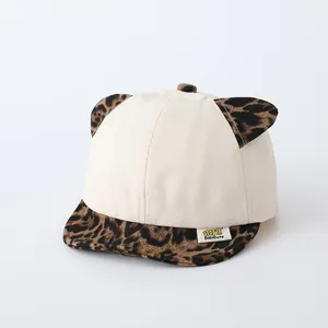 Detail of baby baseball cap with leopard print cat ears and soft brim design