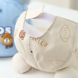 Detail of adjustable velcro strap on beige canvas kids hat with cute bear print