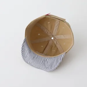 Detail of baby baseball cap interior showing six-panel cotton construction and air vents