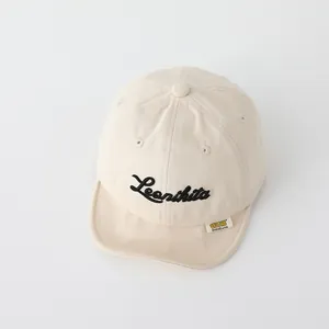 Close-up of beige cotton baby baseball cap with Leonibita embroidery and soft breathable eyelets