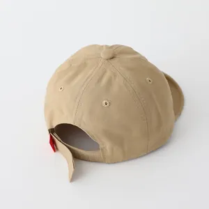 Detail view of khaki cotton baby baseball cap with adjustable velcro strap and red label