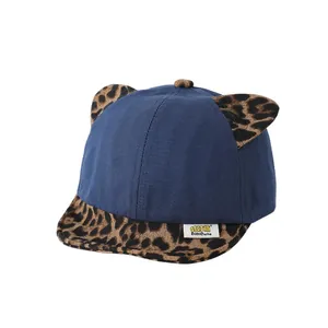 Navy blue baby baseball cap with leopard print ears and brim, made of soft cotton canvas