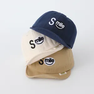 Three soft cotton baby baseball caps with Smile embroidery in navy, beige, and khaki