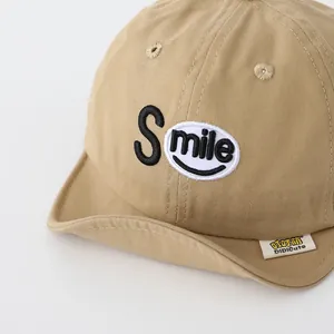 Khaki cotton baby baseball cap with smile embroidery and a soft brim for sun protection