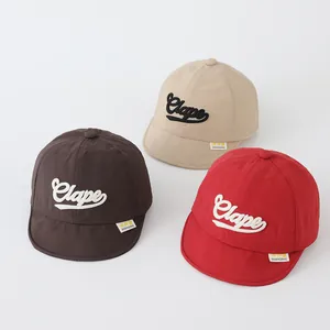 Detailed view of quick-dry baby baseball caps in brown, beige, and red colors