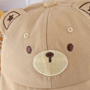Detailed embroidery of a khaki bear fisherman hat for babies with cute soft ears