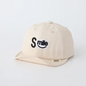 Detail of baby smile baseball cap showing soft brim and high-quality cotton embroidery