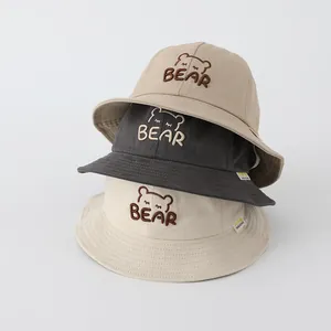 Dettaglio del ricamo dell'orso e del testo BEAR sui cappelli a secchiello in cotone bimbi