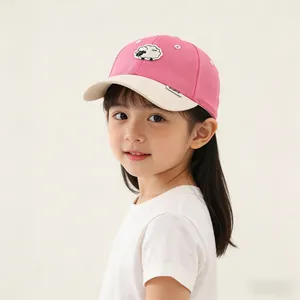 Close-up of pink and beige kids baseball cap featuring cute sheep embroidery and soft texture