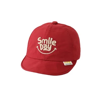 Red baby baseball cap with Smile Day embroidery and breathable mesh cotton texture