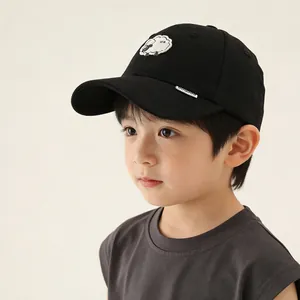 Detailed close-up of a black cotton kids baseball cap featuring a cute sheep patch design