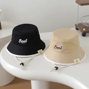 Detail of baby sun hats featuring Best YM letters and adjustable windproof straps