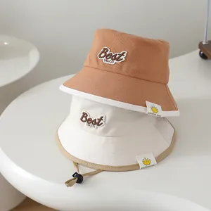 Detail of baby sun hat with Best embroidery, crown label and adjustable chin strap