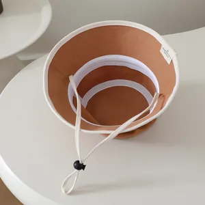 Detail of baby sun hat interior with adjustable windproof drawstring and sweatband