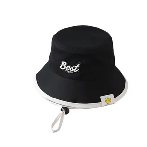 Black cotton baby bucket hat with white brim and Best YM.CO embroidery and chin strap