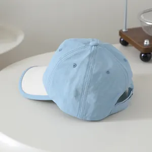 Detail of light blue and white quick-dry baseball cap showing adjustable back strap