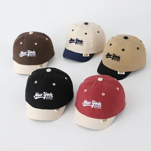 Detailed view of color-blocked kids cotton baseball caps with New York embroidery