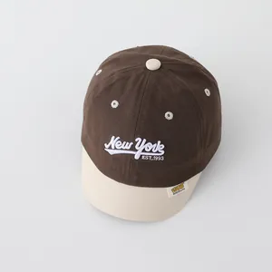 Detailed close-up of New York embroidered baby baseball cap with soft cotton texture