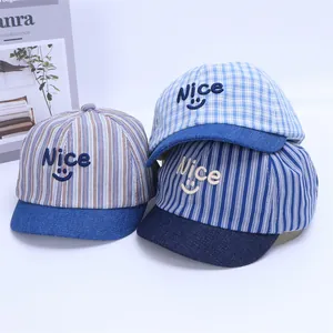 Detail of striped baby caps featuring Nice embroidery and blue denim brims in various colors