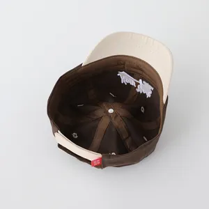 Close-up of the internal stitching and adjustable back strap on the baby baseball cap