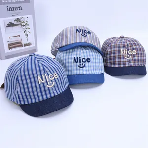 Close-up of a soft stripe baby baseball cap featuring Nice smile embroidery and denim brim