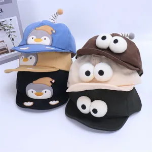 Detailed collection of cartoon baby baseball caps with cute large eyes and penguin embroidery