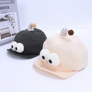 Cute cartoon big eye baby baseball caps in green and beige with soft brims and antennas