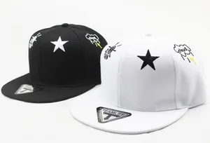Detailed embroidery of star, rocket, and cloud on black and white kids' snapback hats