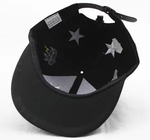 Detailed interior of a black baseball cap featuring star embroidery and an adjustable strap