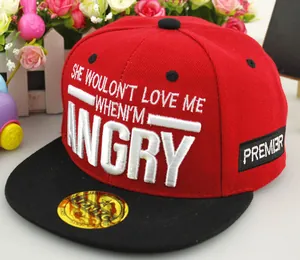 Detailed view of red and black kids snapback cap with white ANGRY letter embroidery