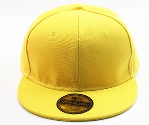 Detail of yellow cotton twill baseball cap with golden holographic brim sticker