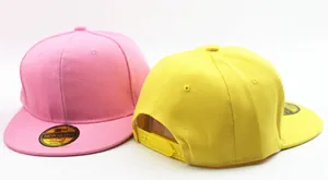 Detail of pink and yellow snapback hats showing the adjustable plastic back strap