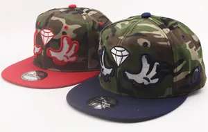 Detail of snapback caps with camouflage crown, flat brim, and diamond glove embroidery