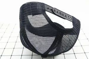 Detail of breathable mesh and adjustable snapback closure on kids black trucker cap