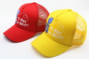 Detail of red and yellow mesh baseball caps for kids featuring cartoon T-Rex prints