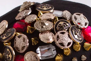 Detailed close-up of skull baseball cap featuring gold lion studs and red gemstones