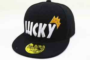 Detail of LUCKY 3D embroidery and yellow crown on black flat-brimmed snapback hat
