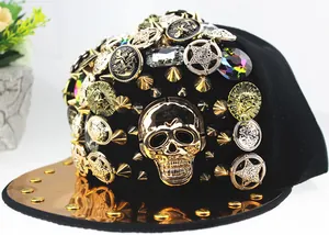 Punk snapback hat with gold skull, metallic rivets and shiny rose gold brim detail